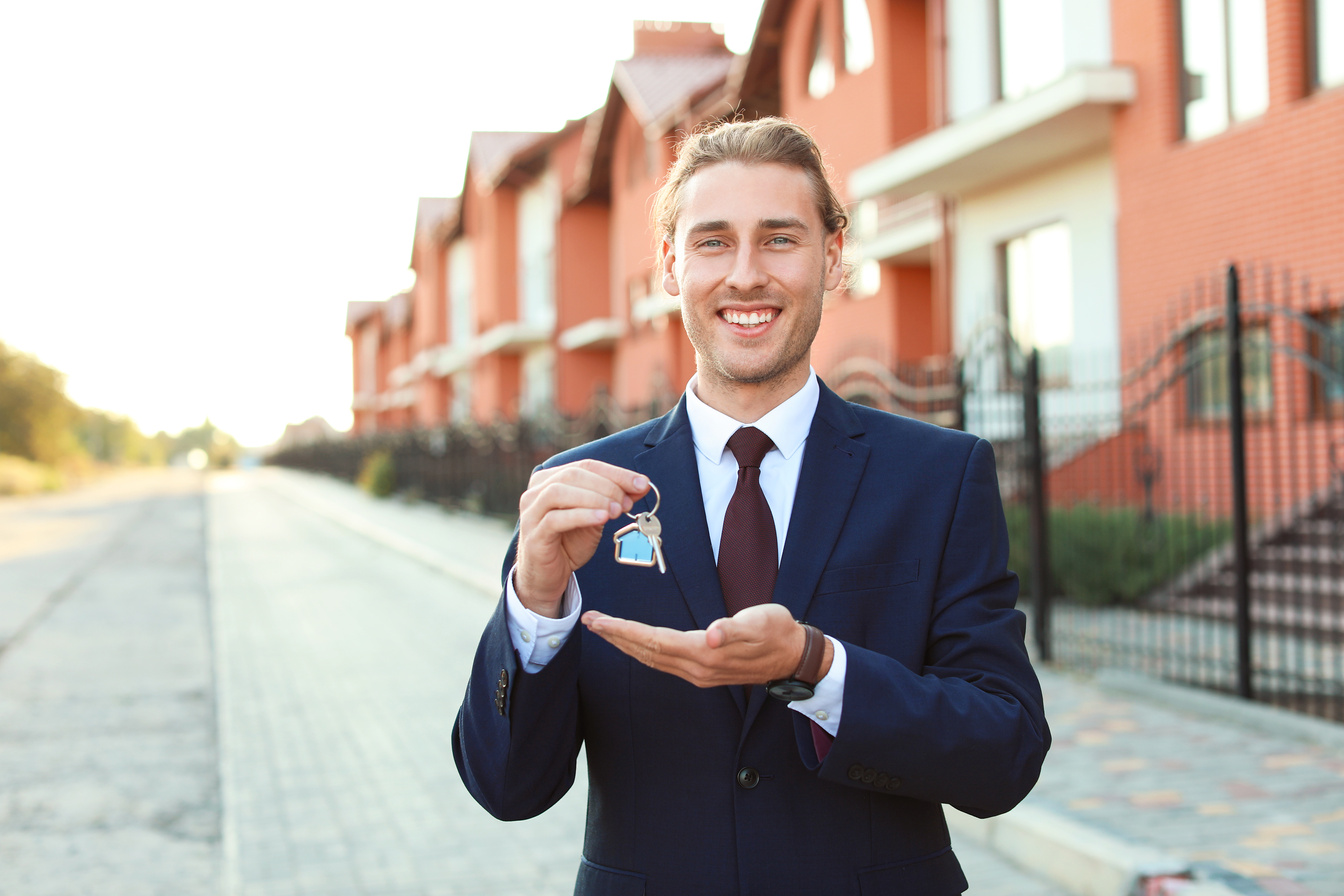 Male Real Estate Agent with Key Outdoors